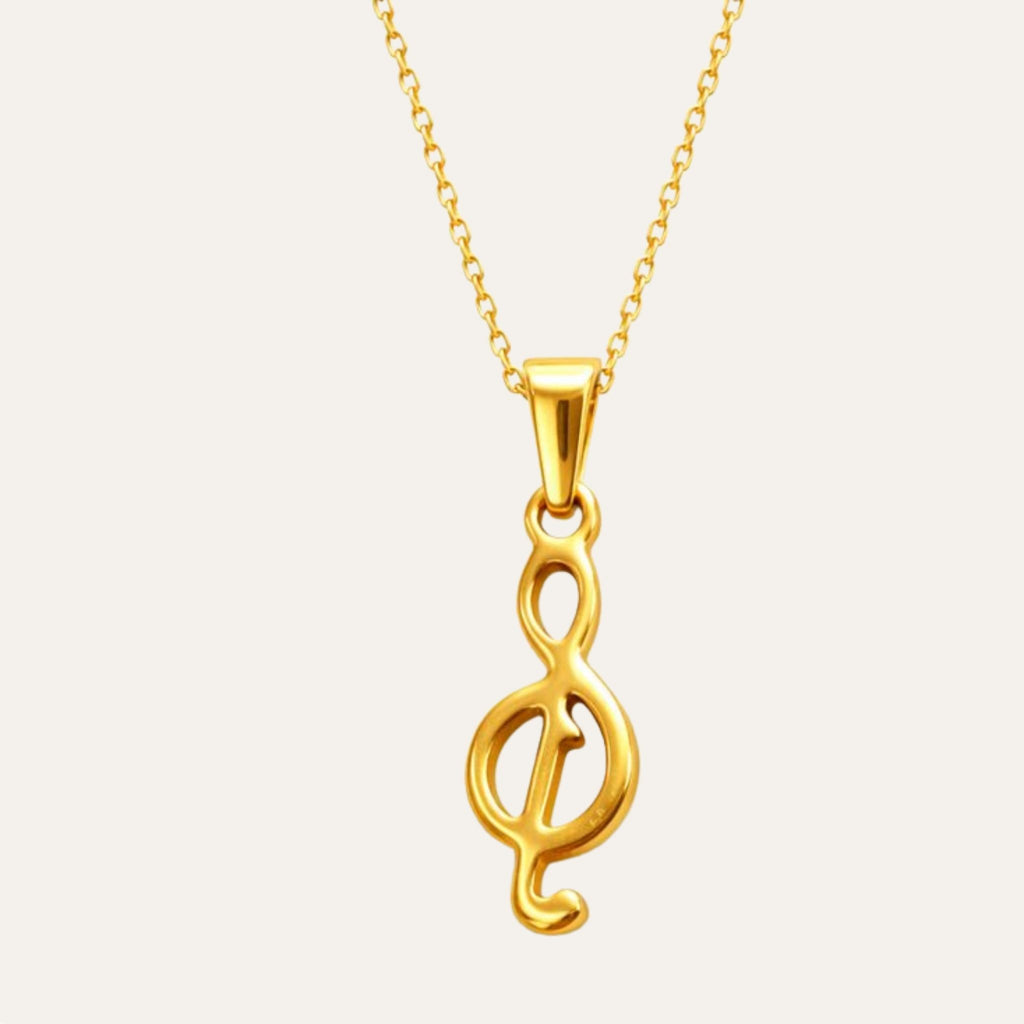 Gold necklace with a unique pendant on a light gray background