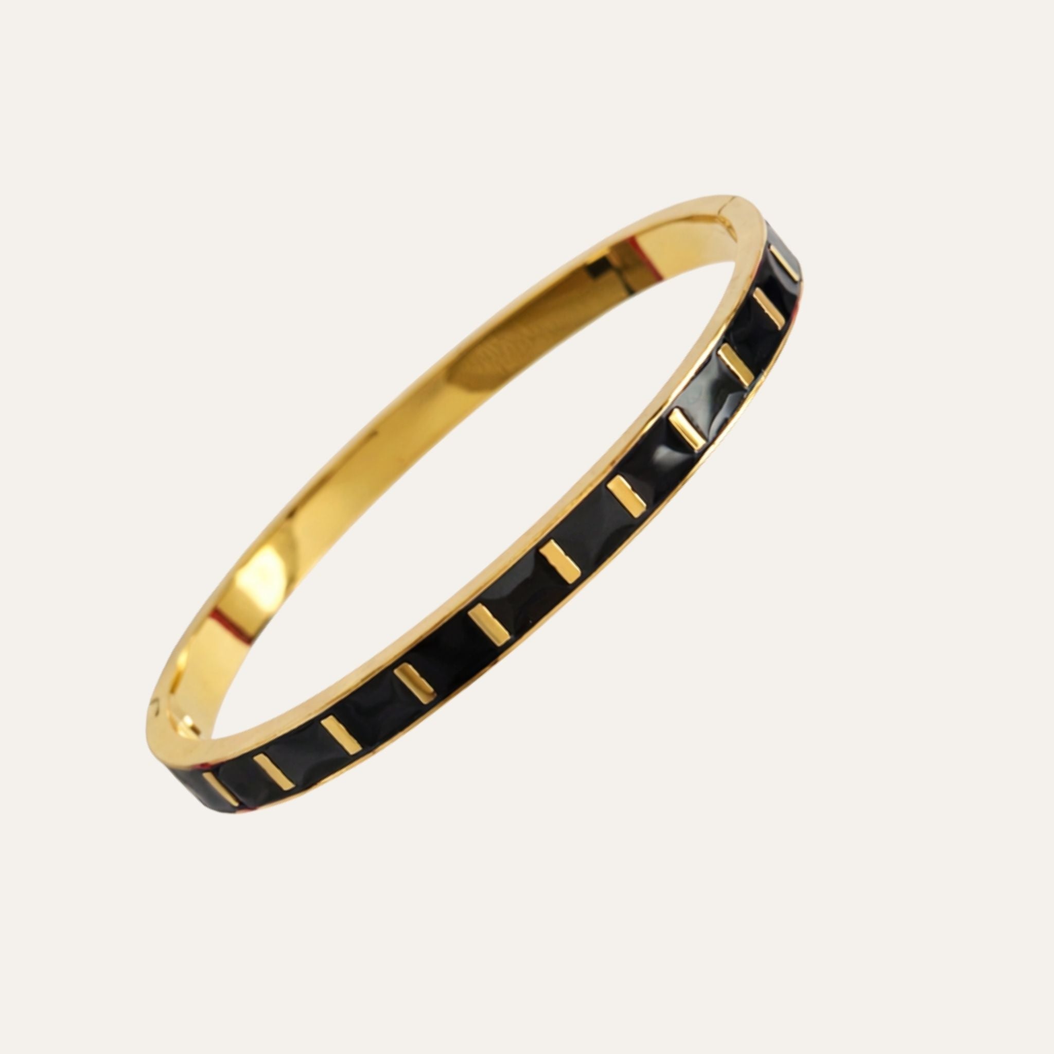 Gold and black bangle on a white background